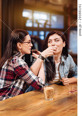 Two pretty women crossing their hands while 29366141