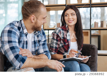 Delighted beautiful woman sitting with her male Delighted beautiful woman sitting with her male 29366992