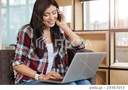 Delighted happy woman holding a laptop 29367053
