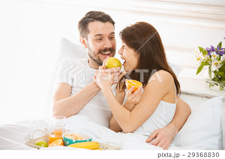 Relaxed Couple in Bed in bedroom at home Relaxed Couple in Bed in bedroom at home 29368830