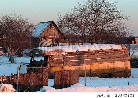 Old rusty and collapsed bus shrouded in snow. 29370201