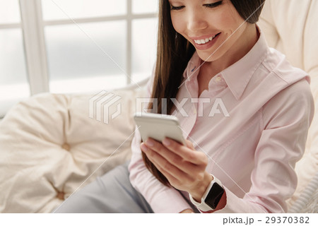 Outgoing young female looking at mobile Outgoing young female looking at mobile 29370382