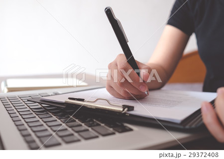 Female writing resume to get new job 29372408