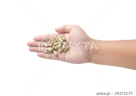 Hand holding medicine pills isolated on white 29373275