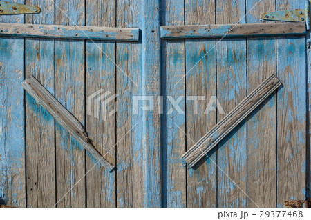 Close up of old barn door painted blue Close up of old barn door painted blue 29377468