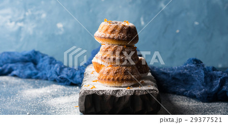 Bundt cakes on dark background and serving board Bundt cakes on dark background and serving board 29377521