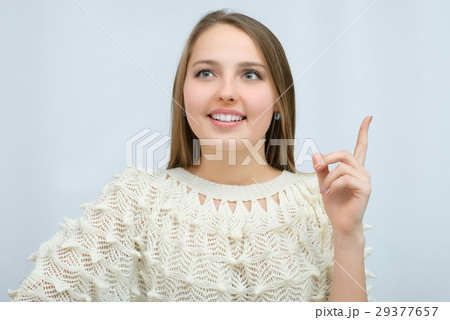 Young girl with long curly hair posing on blue Young girl with long curly hair posing on blue 29377657