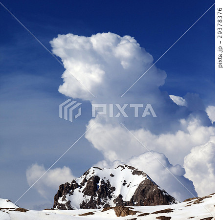 Rocks in snow and blue sky with clouds 29378376
