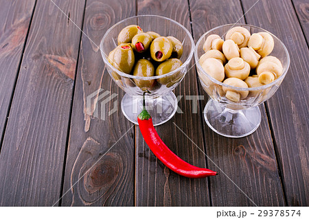 Glass bowsl with olives and pickled mushrooms  29378574