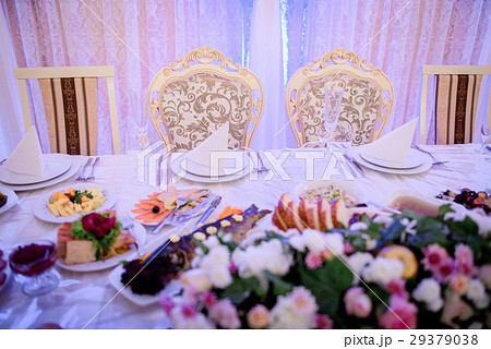 Chairs with golden design stand at dinner table Chairs with golden design stand at dinner table 29379038