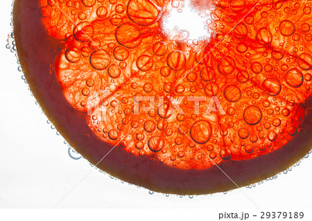Air bubbles cover slice of grapefruit floating  Air bubbles cover slice of grapefruit floating  29379189