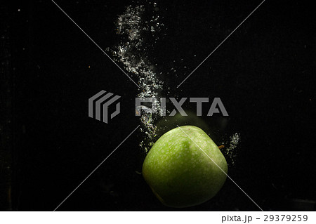 Organic green apple falls in water before Organic green apple falls in water before 29379259
