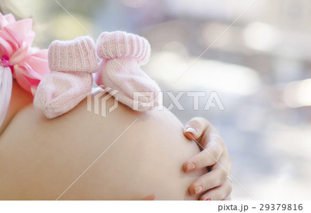 pregnant woman's belly with booties on it pregnant woman's belly with booties on it 29379816