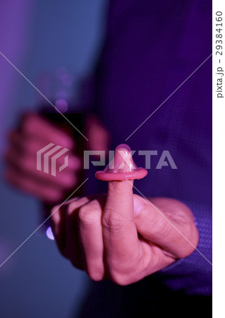 young man with condom and mixed drink 29384160