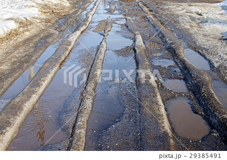 Melting ice on the road in spring 29385491
