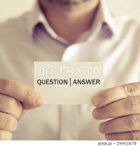 Businessman holding QUESTION ANSWER message card Businessman holding QUESTION ANSWER message card 29401678