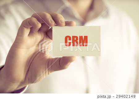Businessman holding CRM message card Businessman holding CRM message card 29402149