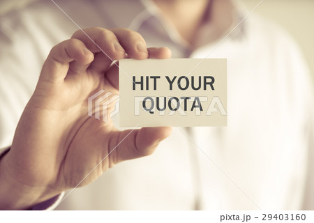Businessman holding HIT YOUR QUOTA message card Businessman holding HIT YOUR QUOTA message card 29403160