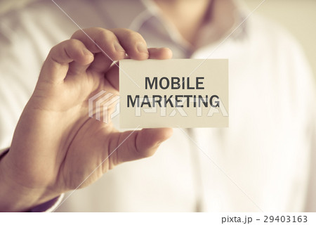 Businessman holding MOBILE MARKETING message card Businessman holding MOBILE MARKETING message card 29403163