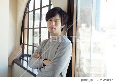 窓際で腕組みしてくつろぐ20代男性 窓際で腕組みしてくつろぐ20代男性 29404047