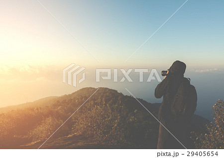 silhouette man shoot photo on peak of mountain 29405654
