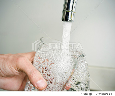 man filling a glass of tap water man filling a glass of tap water 29408934