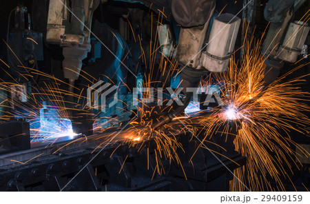 Robots are welding metal part in factory Robots are welding metal part in factory 29409159