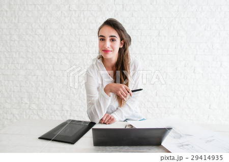 Female designer looking at camera on workplace Female designer looking at camera on workplace 29414935