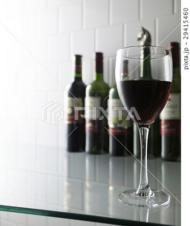 Glass of wine on glass shelf 29415460