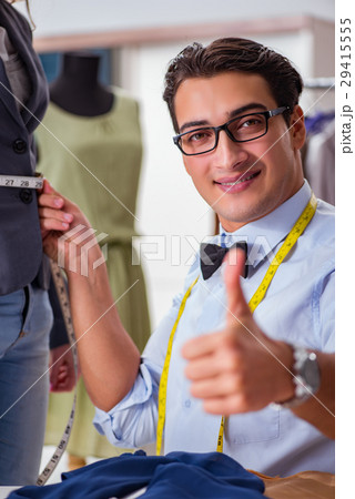 Young man tailor working with female client Young man tailor working with female client 29415555
