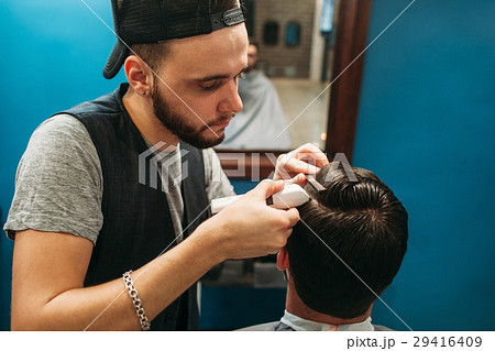 Young barber cut man hair free space Young barber cut man hair free space 29416409