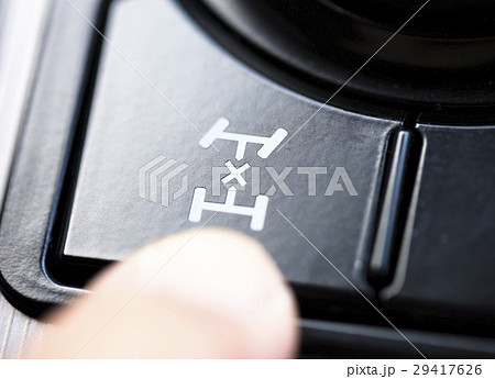 finger pressing the 4wd button in car 29417626