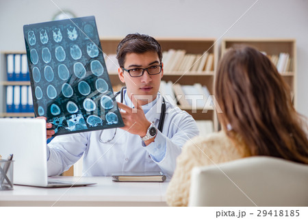 Young doctor looking at computer tomography x-ray Young doctor looking at computer tomography x-ray 29418185