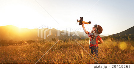 Child pilot aviator with airplane dreams of traveling in summer Child pilot aviator with airplane dreams of traveling in summer 29419262