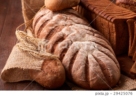 Different kinds of bread on burlap on the wooden 29425076