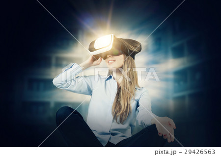 Woman wears virtual reality glasses 29426563
