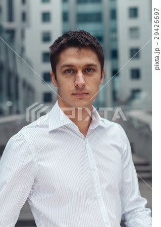 Smiling relaxed businessman standing in an urban Smiling relaxed businessman standing in an urban 29426697