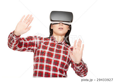 Shocked woman playing game in virtual reality and 29433927