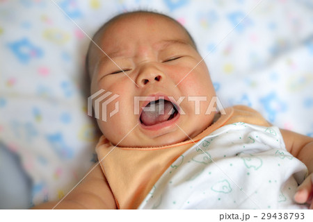 New born asian baby crying on bed New born asian baby crying on bed 29438793