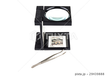 World postage stamps and magnifying glass  29439888