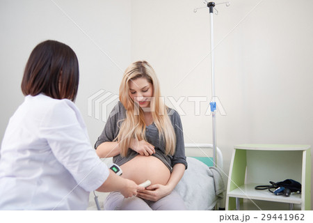 Pregnant woman having ultrasonic scanning at the Pregnant woman having ultrasonic scanning at the 29441962
