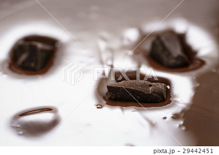 pieces of dark chocolate drowning in melted pieces of dark chocolate drowning in melted 29442451