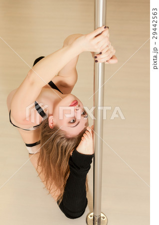 Professional pole dance woman sitting on the floor Professional pole dance woman sitting on the floor 29442563
