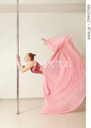 Slim poledance girl posing in beautiful pink dress Slim poledance girl posing in beautiful pink dress 29442566