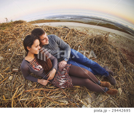 Happy couple lying down at autumn background Happy couple lying down at autumn background 29442695