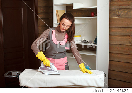 Young woman in uniform with steam iron 29442822