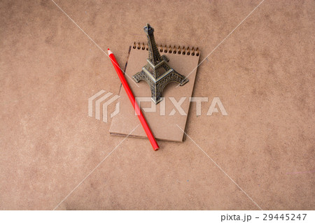 Little model Eiffel Tower, notebook and pencil Little model Eiffel Tower, notebook and pencil 29445247