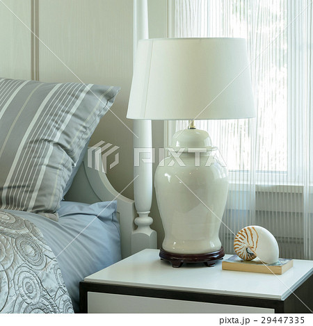 cozy bedroom with pillows and reading lamp 29447335