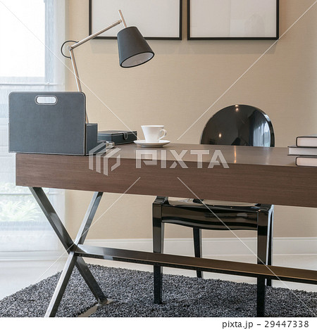 wooden table and books in modern working room 29447338