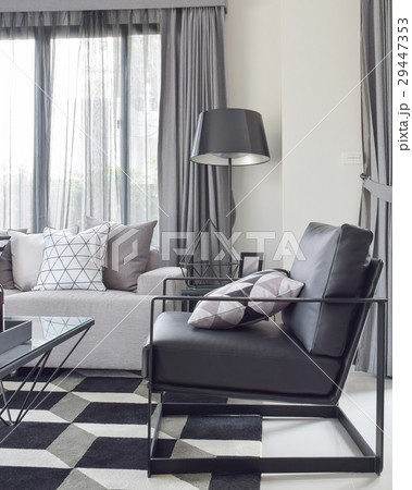 Black armchair with geomatric rug in living room 29447353